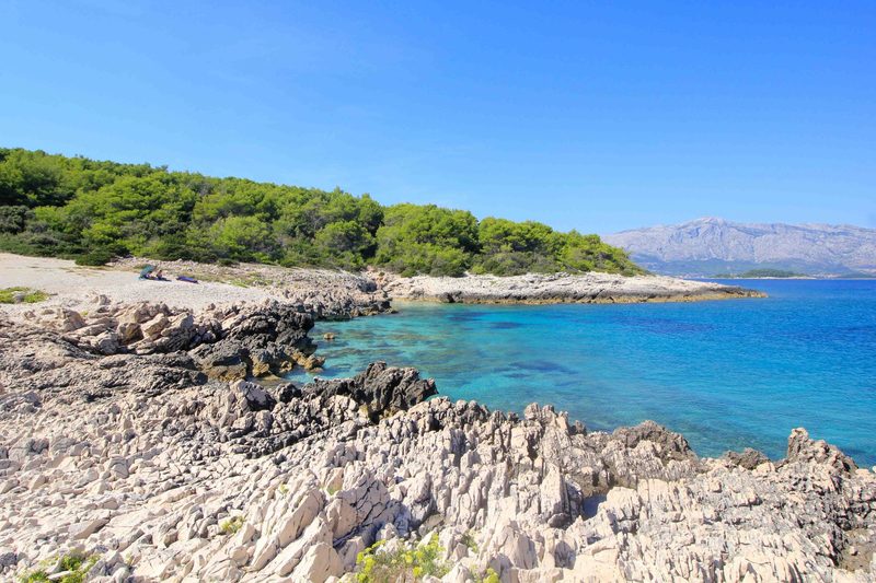Raznjič rocky beach Lumbarda — crystal clear water perfect for snorkelling